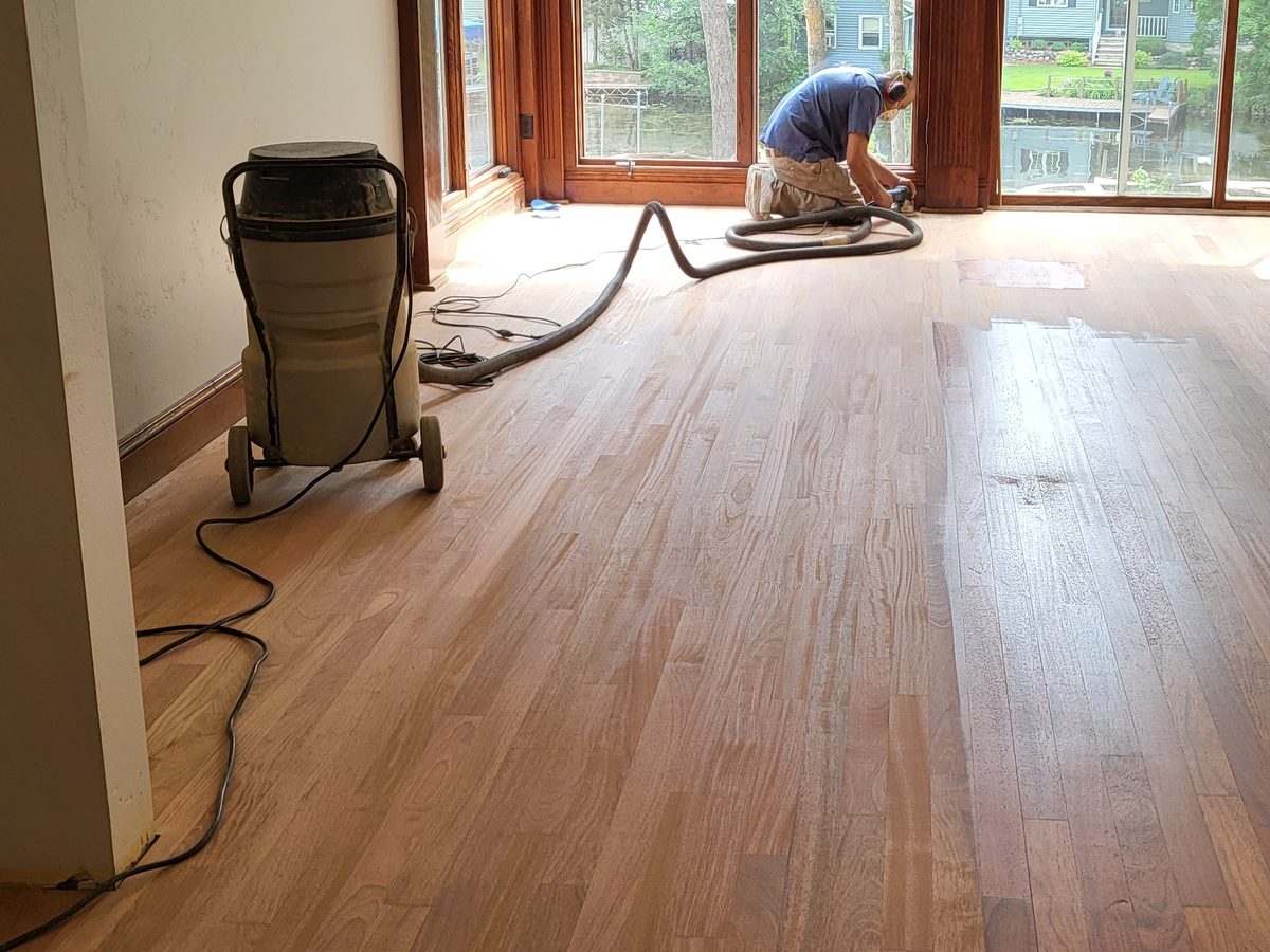 Milwaukee living room oak floor sanded to raw wood, edger work along the window wall